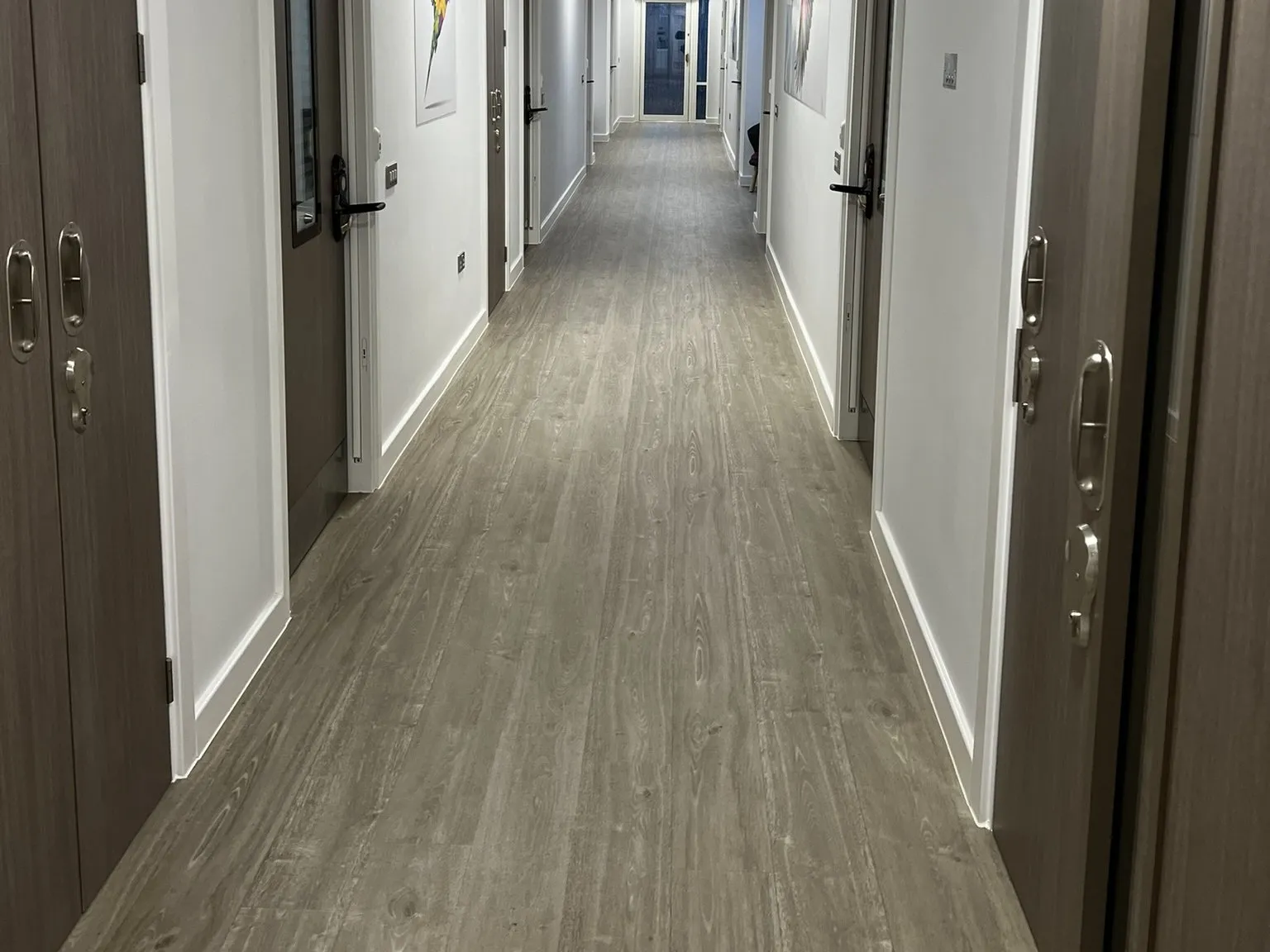 A long bedroom corridor in wood-effect safety vinyl