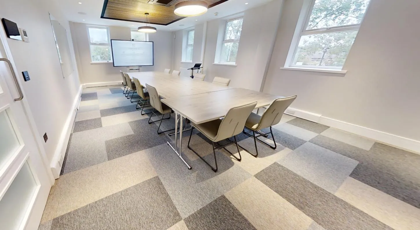 Carpet tiles in a mix of grey and oatmeal tones in the meeting room at Abbey House Dental