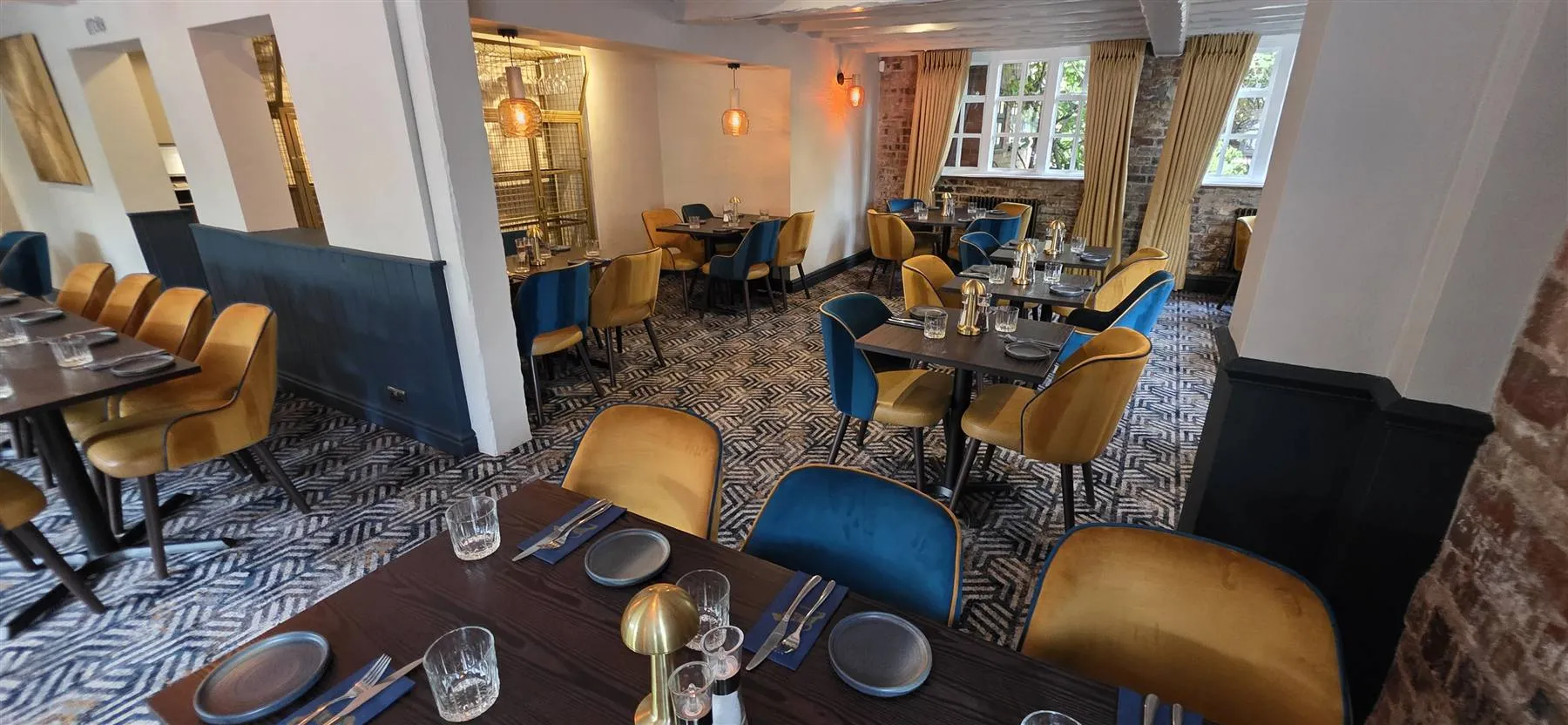 Restaurant with exposed beams, brick and the geometric Calderdale carpet