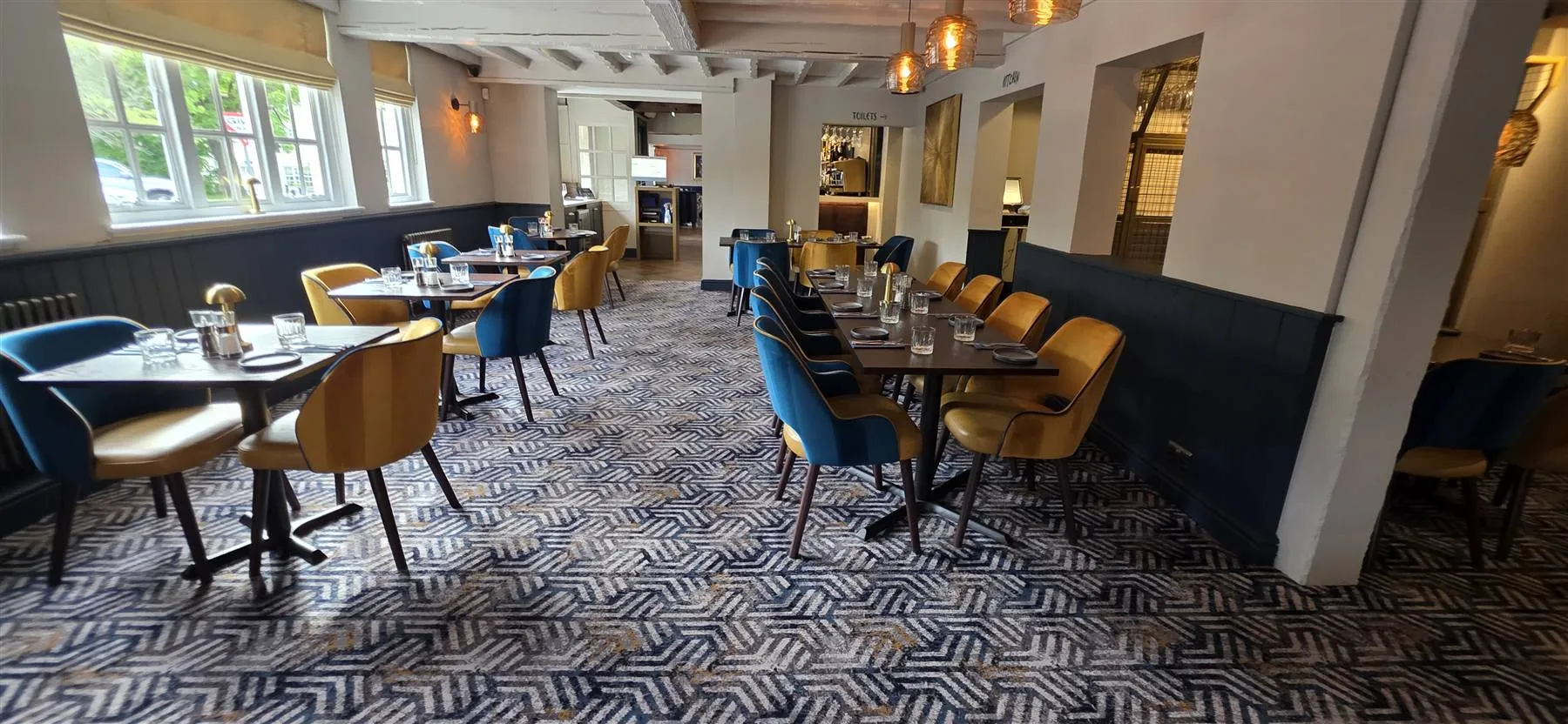 Patterned Calderdale carpet through the restaurant, set against blue panelling
