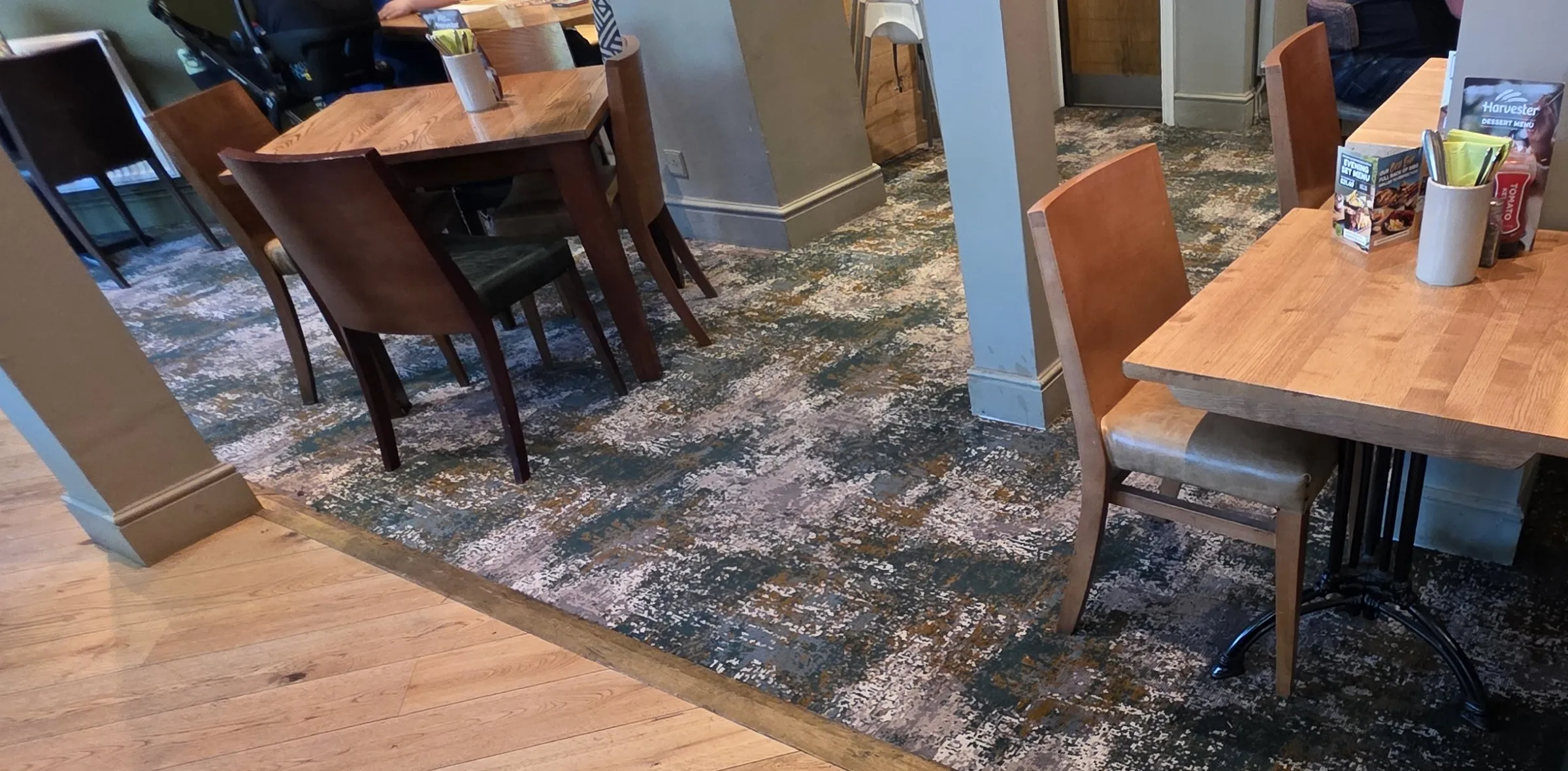 Patterned carpet through the dining area at a Harvester in West Byfleet, beside the existing timber floor