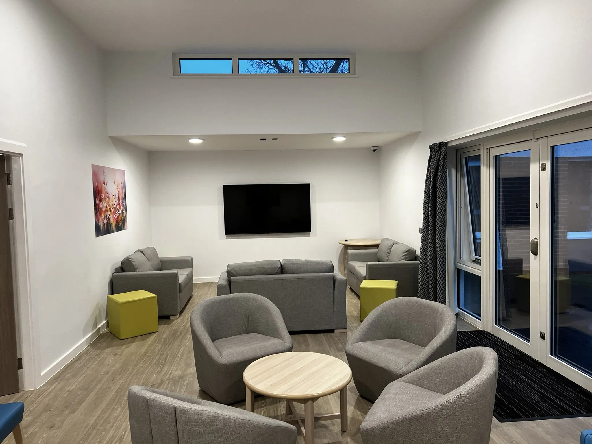 Wood-effect safety vinyl through the lounge, with matting at the garden doors