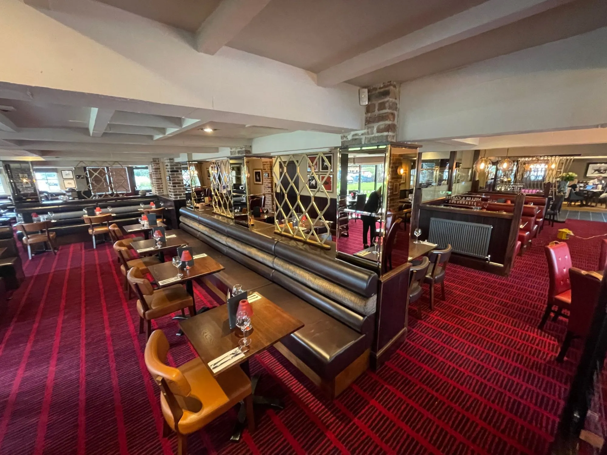 Red striped carpet through the dining room at Miller & Carter, Sarn