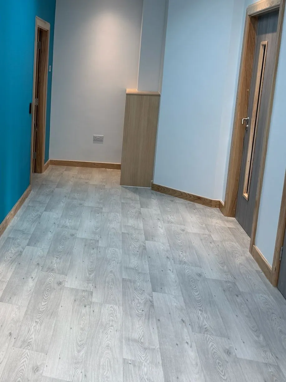 Polyflor Forest FX through the reception area, beside a blue feature wall